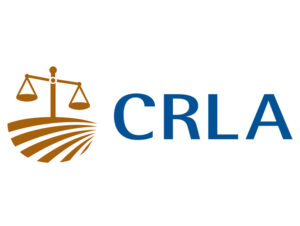 CRLA Logo consisting of the scales of justice over farmland