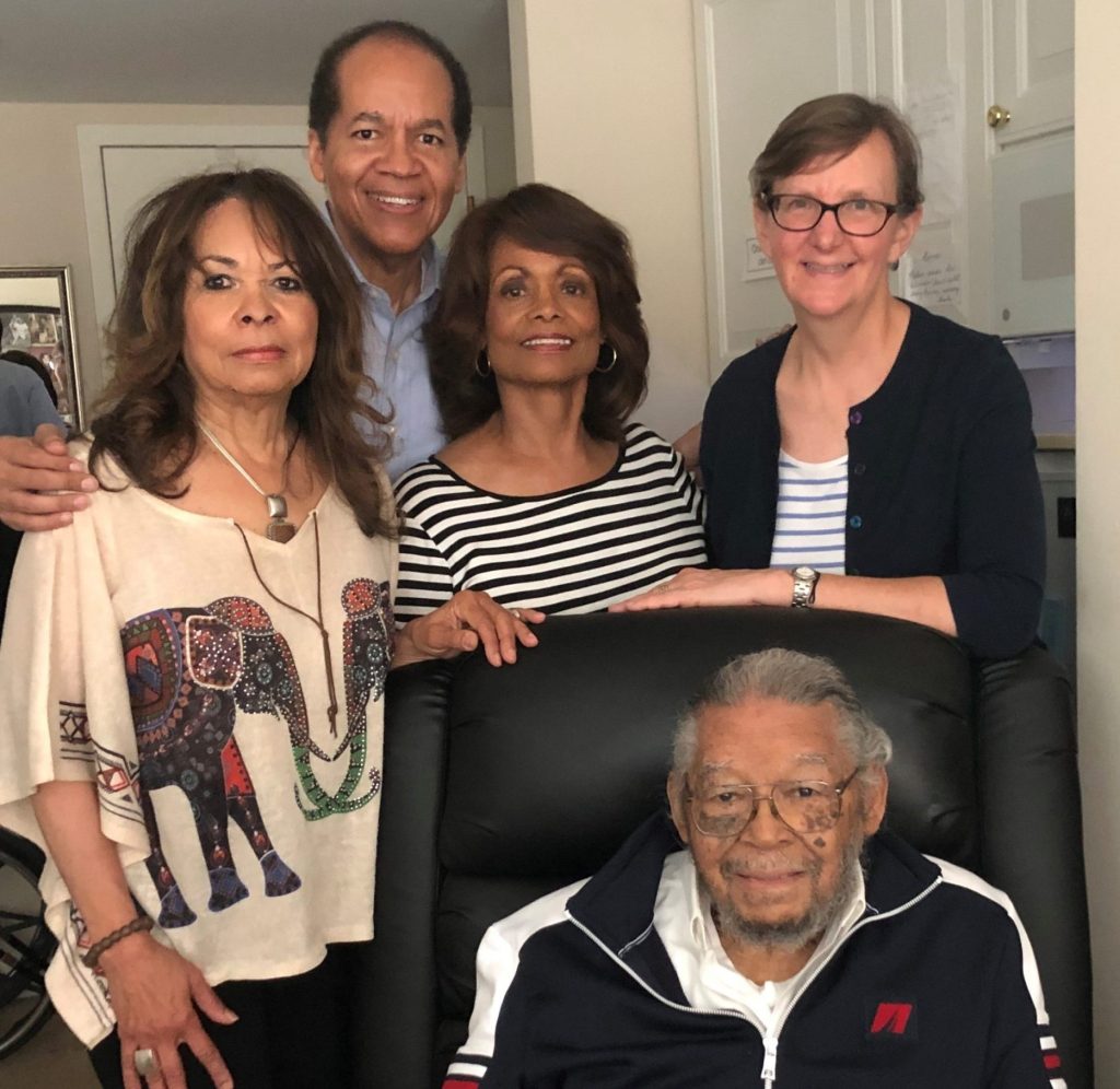 Nelson (seated) with family and LAAW attorney Elizabeth Kristen