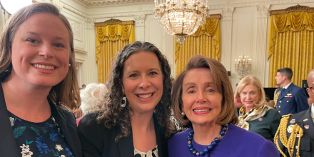 Nancy Pelosi and Legal Aid at Work Attorneys Julia Parish and Sharon Terman in formal attire at the white house