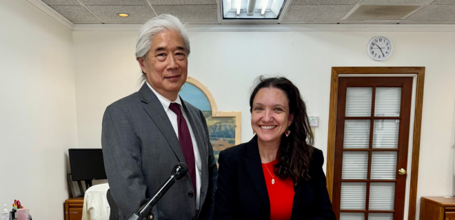 Lawyer Chris Ho of Legal Aid at Work and plaintiff Lauren Gaw stand smiling together in an office.